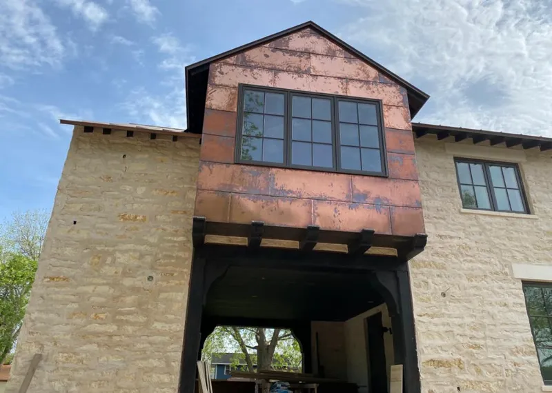 Copper metal panel facade on a stone building for Metal Roof Coating in Amity